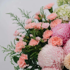Fresh pink peonies and mums bouquet with greenery for flower delivery