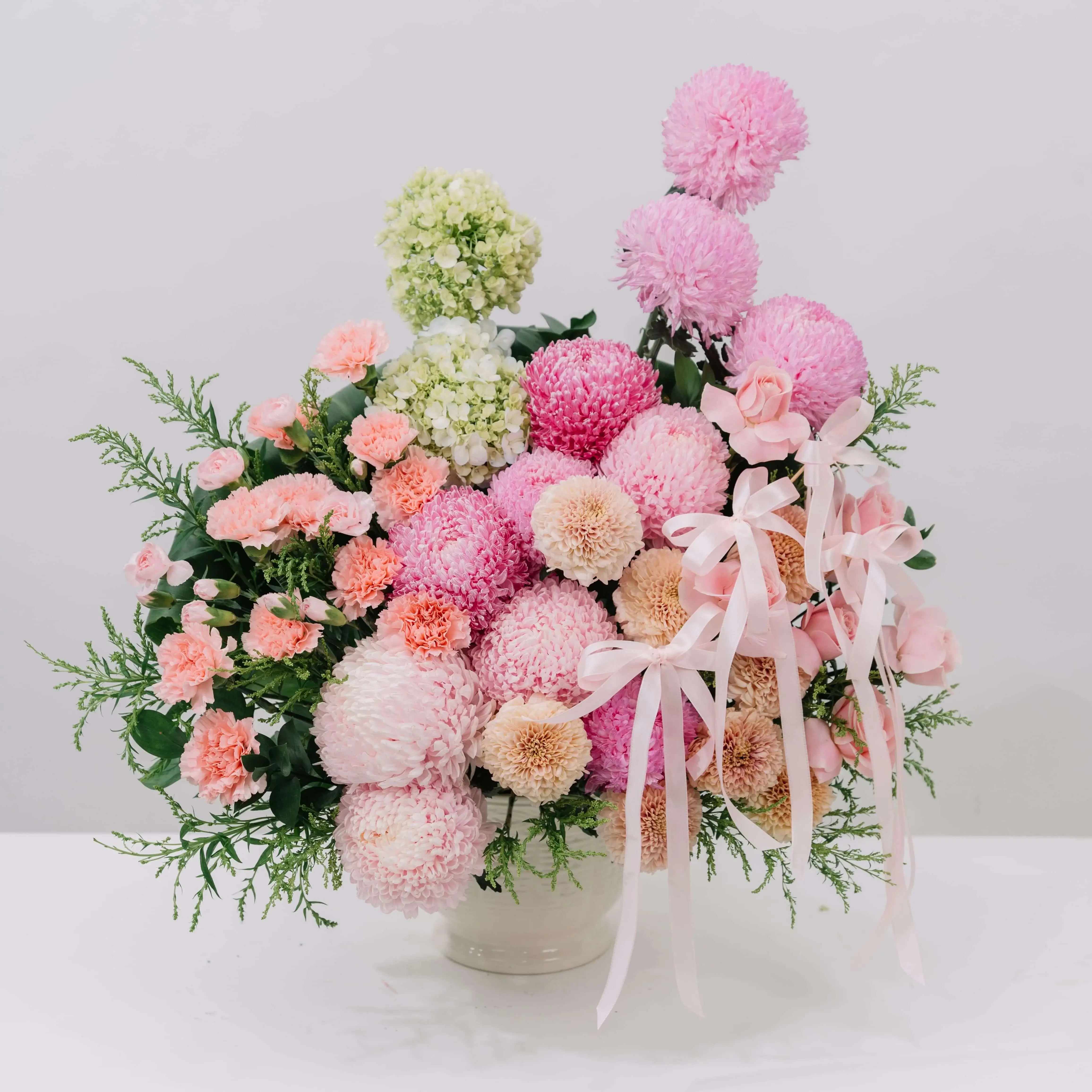 Soft pink peony and mum bouquet with ribbons for flower delivery in Singapore