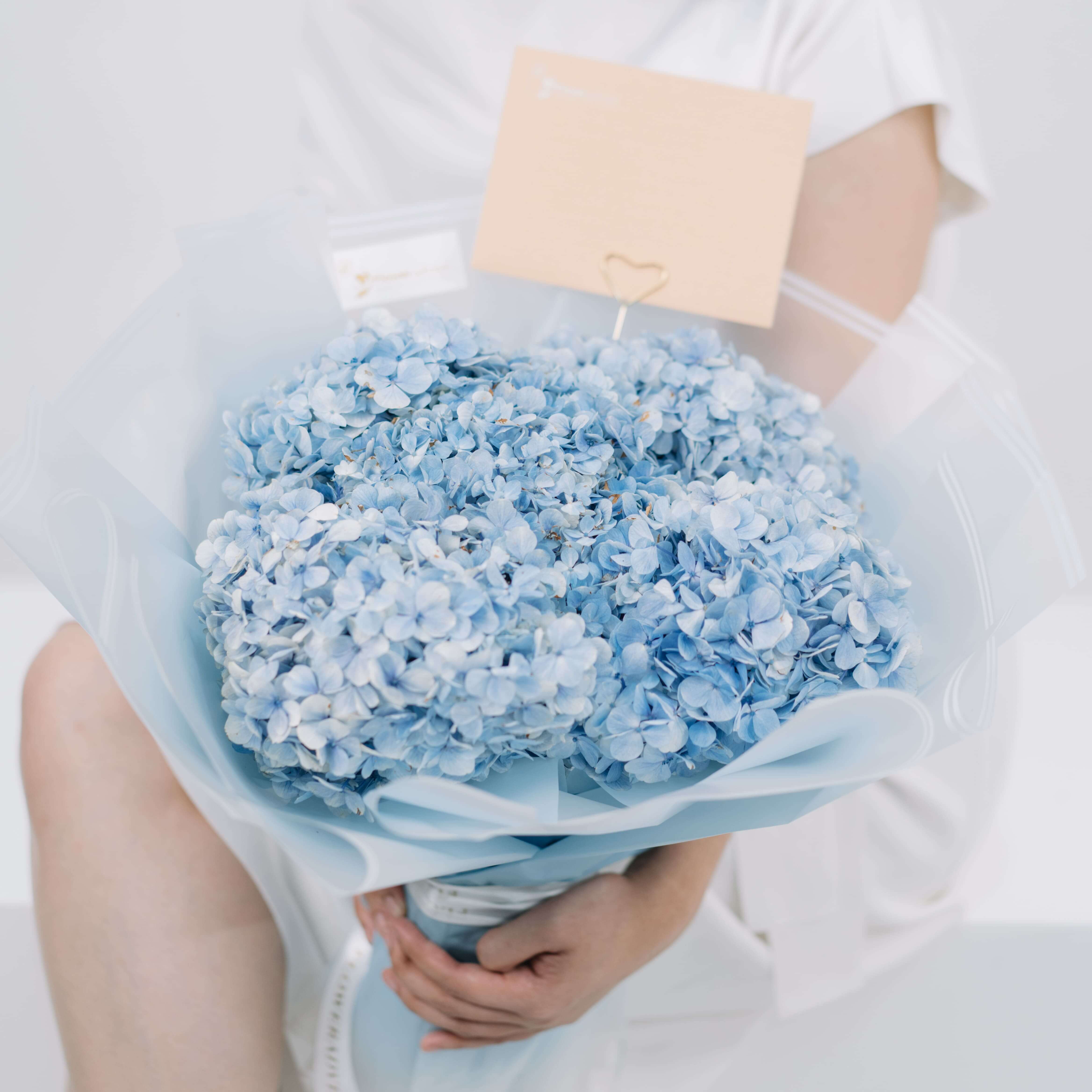 Blue hydrangea bouquet with gift card, ideal for flower delivery in Singapore