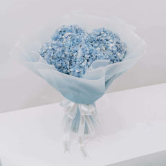 Elegant bouquet of blue hydrangeas wrapped for flower delivery in Singapore