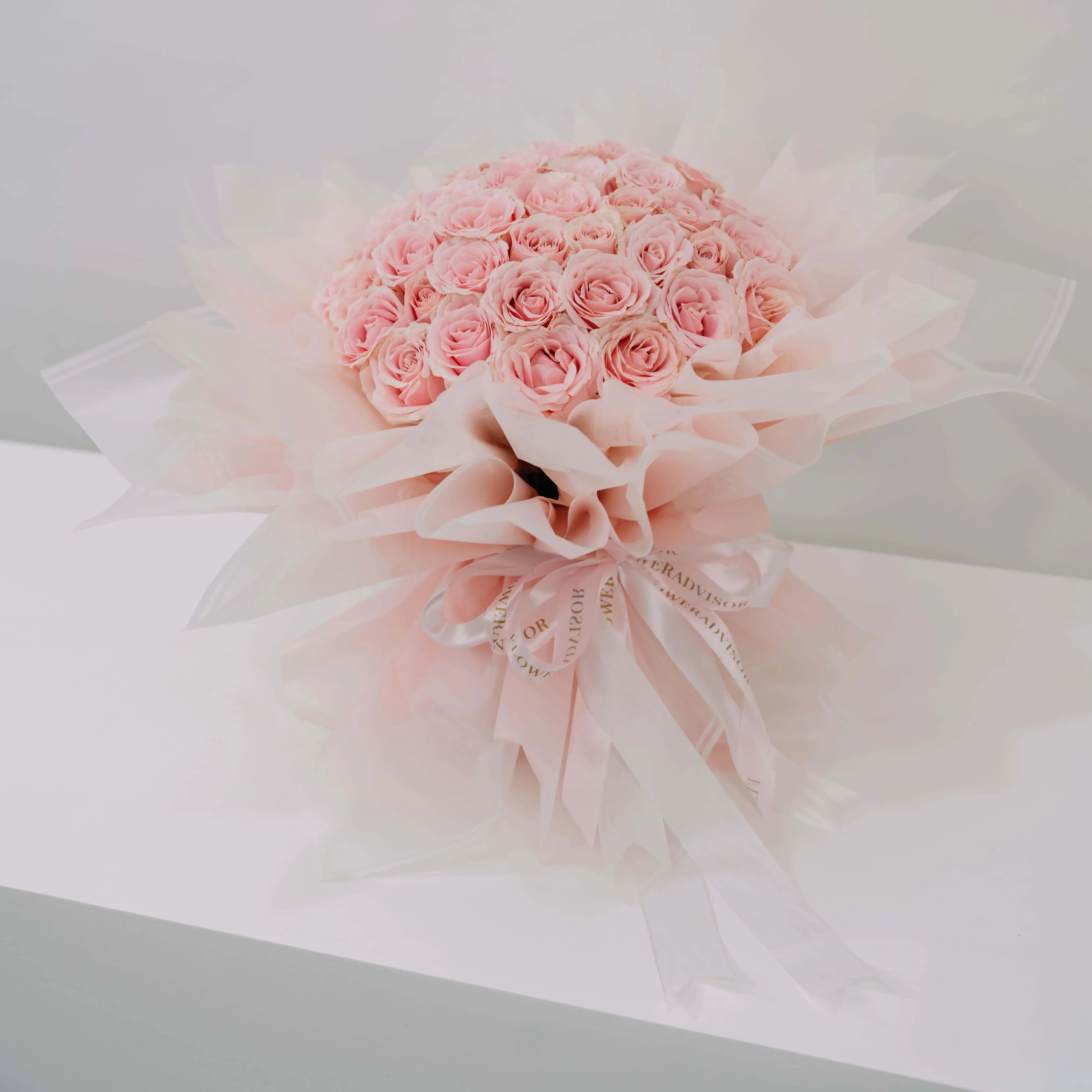 Elegant bouquet of 50 pink roses with soft wrapping, ideal for flower delivery in Singapore
