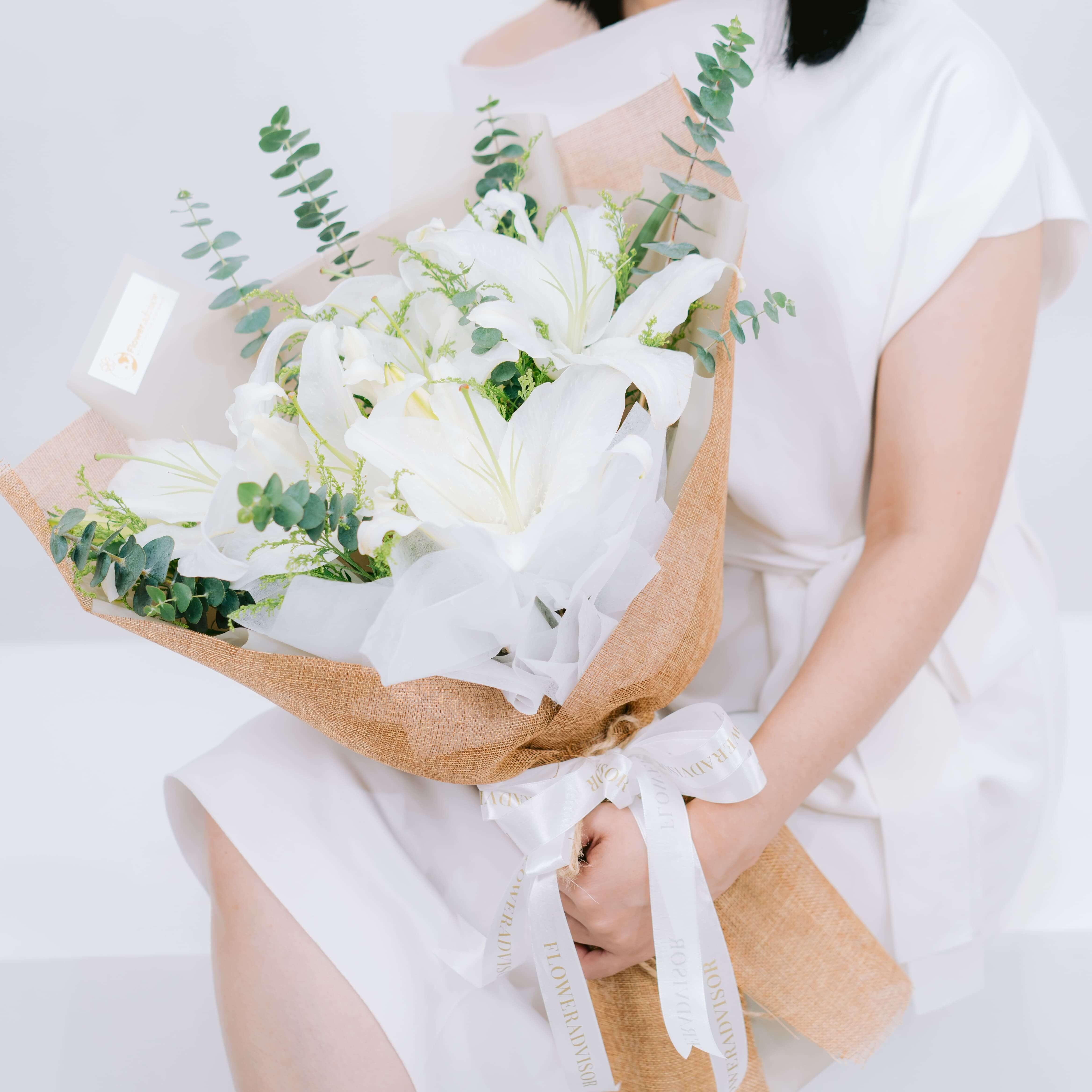 Elegant white lily bouquet with greenery, ideal for flower delivery in Singapore