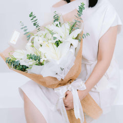 Elegant white lily bouquet with greenery, ideal for flower delivery in Singapore