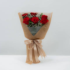 Elegant red rose bouquet wrapped in kraft paper for flower delivery in Singapore
