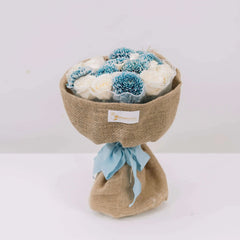 Rustic bouquet with blue and white flowers wrapped in burlap, ideal for flower delivery