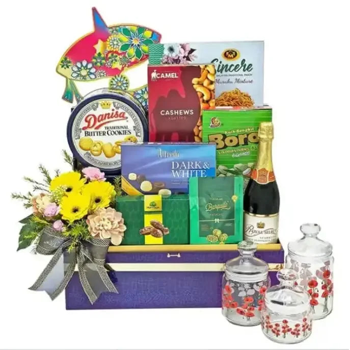 Flower delivery gift hamper with fresh yellow flowers, gourmet snacks, cookies, and tea set