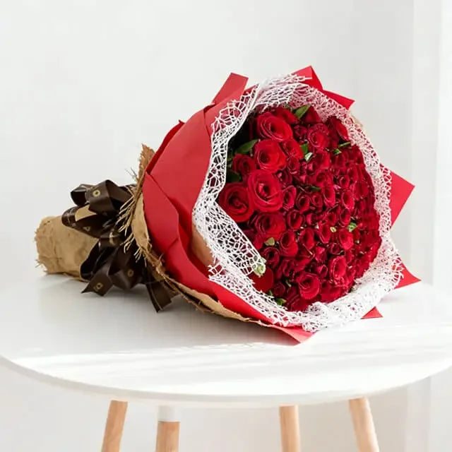 Elegant bouquet of red roses on a table, perfect for flower delivery in Singapore