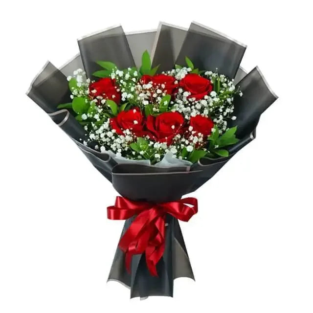 Red rose bouquet with baby’s breath and greenery in black wrapping for flower delivery